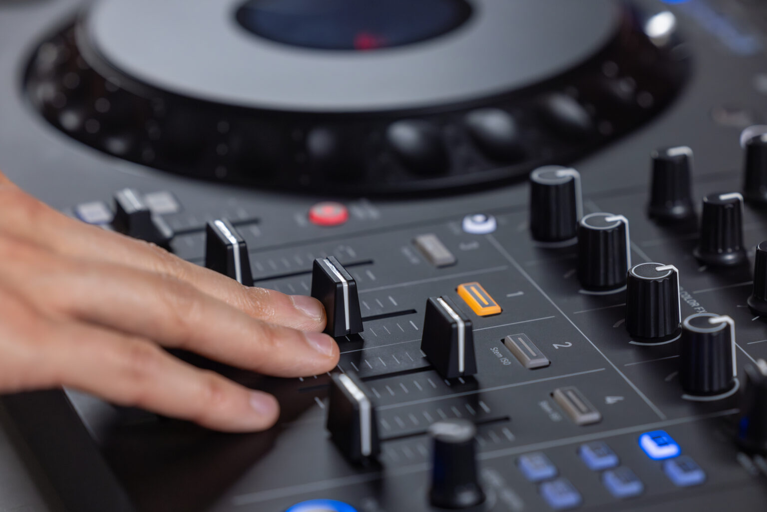 Close-up of the DDJ-GRV6 controller's channel faders, cue buttons and mixer controls